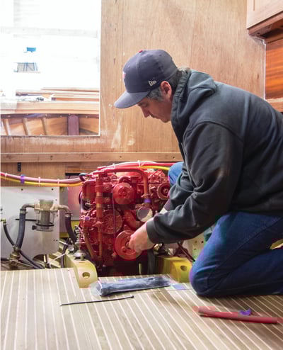 Jeff works on diesel engine in troller project.